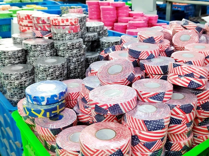 Customized logo and pattern hockey tape has been manufactured and is ready for packaging and shipping including designs such as the American flag Canadian flag skull and crossbones and Swedish flag Customized logo and pattern hockey tape has been manufactured and is ready for packaging and shipping including designs such as the American flag Canadian flag skull and crossbones and Swedish flag